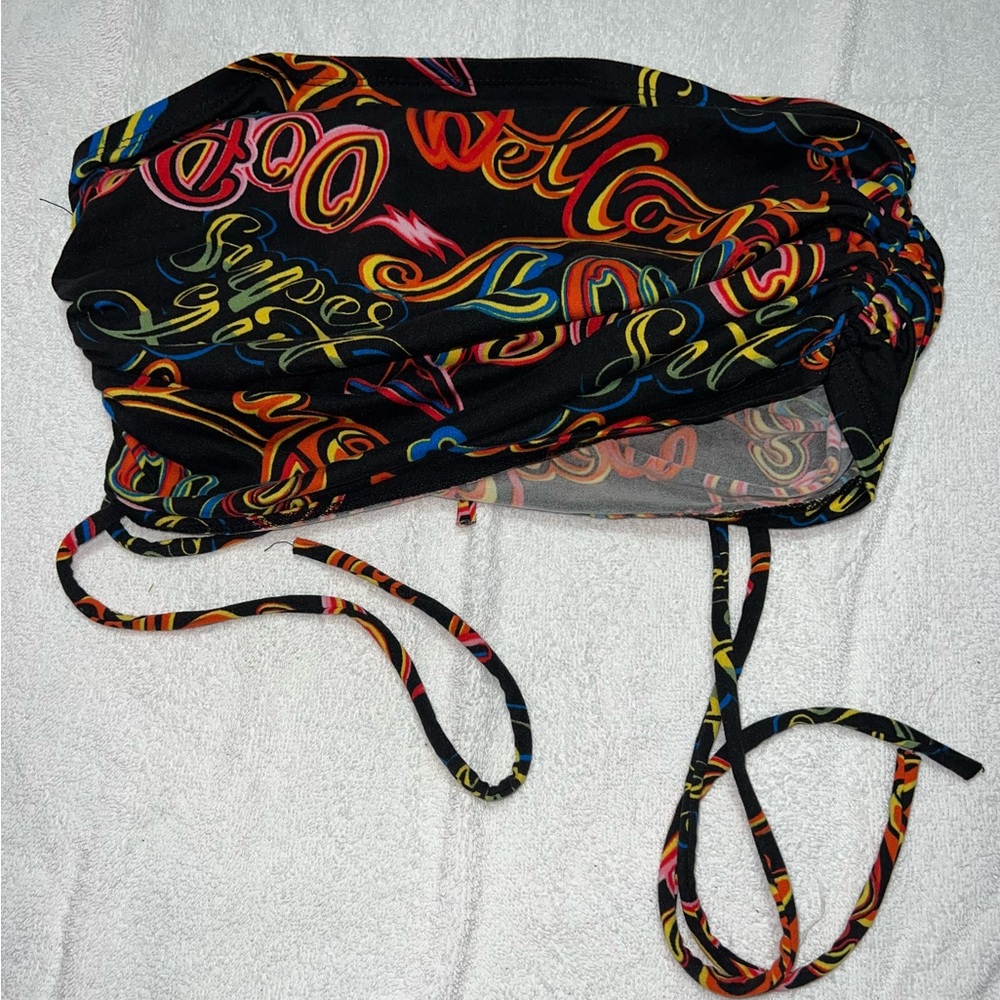 I’m selling this very colorful crop top that’s tied at the sides. It’s silky.